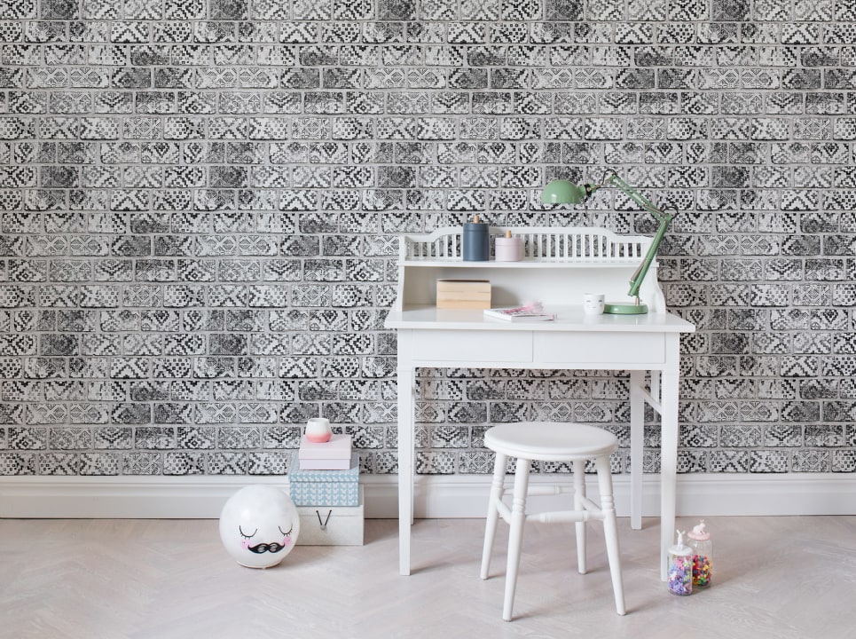 A wall mural with painted bricks in black and white