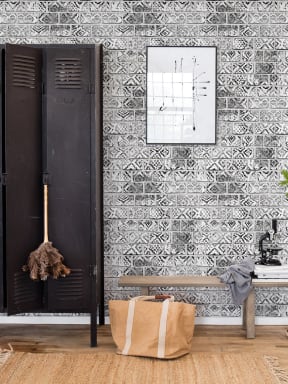 A wall mural with painted bricks in black and white